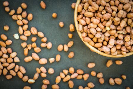 Peanuts in wooden bowl - Healthy food concept