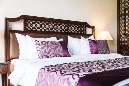 Comfortable pillow on bed decoration in hotel bedroom interiorの写真素材