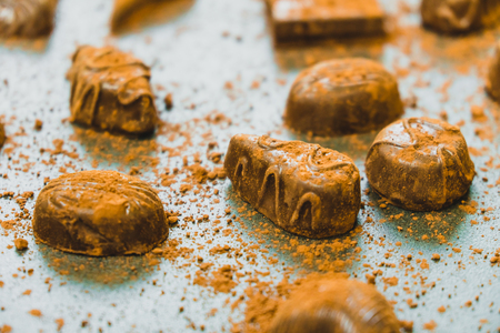 Sweet dessert with dark chocolate pieces and cocoa powder on black stone backgroundの写真素材