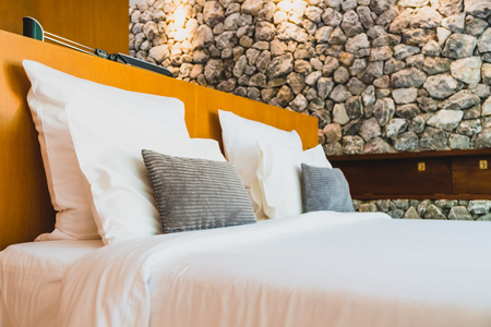 Confortable white pillow on bed decoration interior of bedroomの写真素材