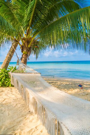 Hammock on the beautiful tropical beach and sea with blue sky - Holiday Vacation conceptの写真素材