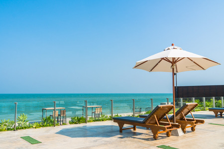 Beautiful umbrella and chair around swimming pool in hotel and resort - vacation conceptの写真素材