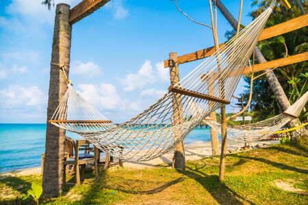 Hammock on the beautiful tropical beach and sea with blue sky - Holiday Vacation conceptの写真素材