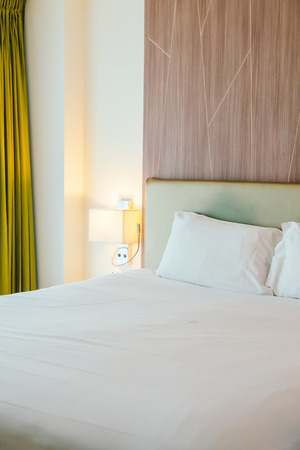 White pillow on the bed decoration in bedroom interiorの写真素材