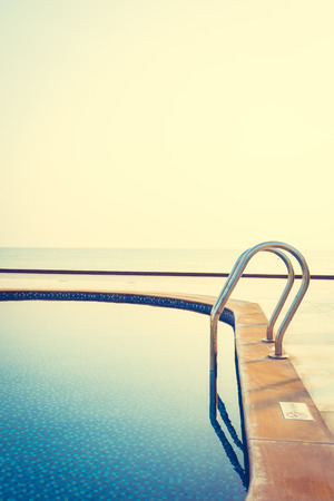 Beautiful luxury outdoor swimming pool in hotel and resort at sunrise time - Vacation conceptの写真素材