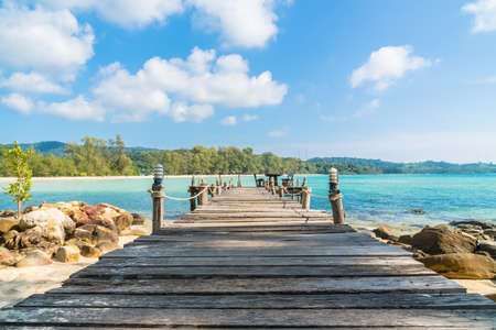 Beautiful island paradise with bridge and coconut palm tree around sea and beach on white cloud and blue sky - Holiday vacation conceptの写真素材