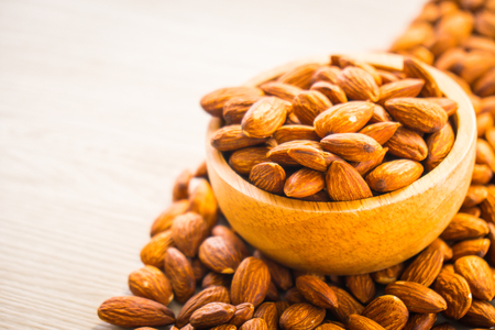 Close up Almonds nut in wooden bowlの写真素材