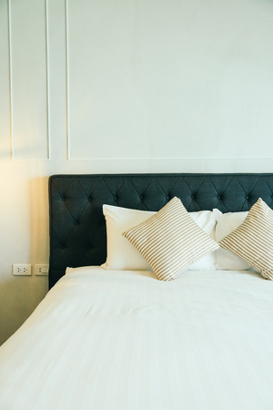 Comfortable pillow on bed decoration in hotel bedroom interiorの写真素材