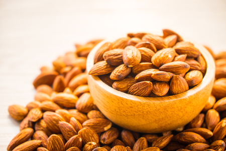 Close up Almonds nut in wooden bowlの写真素材
