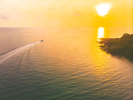 Aerial view of sea and beach with coconut palm tree on island at sunset time