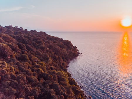 Aerial view of sea and beach with coconut palm tree on island at sunset time
