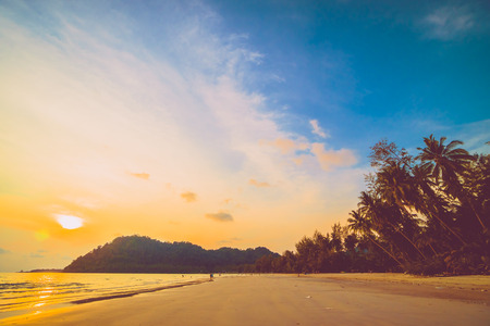 Beautiful tropical beach and sea with coconut palm tree in paradise island  at sunset timeの写真素材