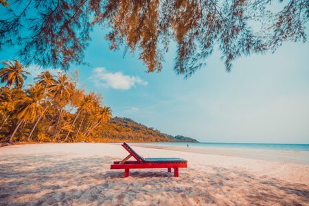Beautiful nature tropical beach and sea with chair and coconut palm tree on paradise island for travel vacationの写真素材