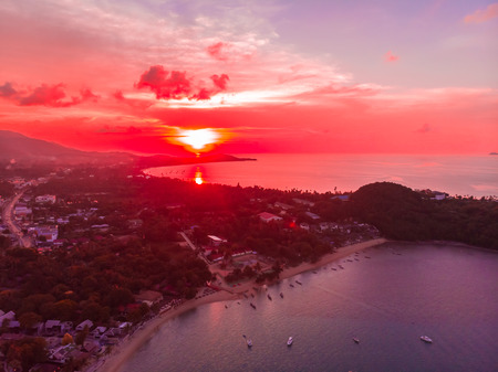 Aerial view of beautiful tropical beach and sea with palm and other tree in koh samui island Thailand at sunset time for vacation and travelの写真素材