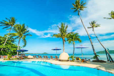 Umbrella and chair around swimming pool in hotel and resort for travel and vacationのeditorial素材