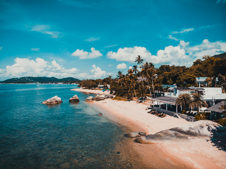 Beautiful aerial view of beach and sea with many tree and white cloud on blue sky in koh samui...
