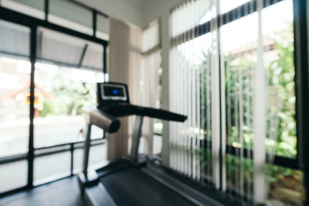 Abstract blur and defocused fitness equipment interior of gym room for background