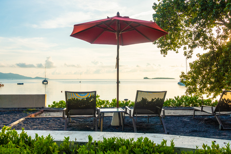 Beautiful tropical sea ocean and beach with umbrella and chair for travel and vacationのeditorial素材