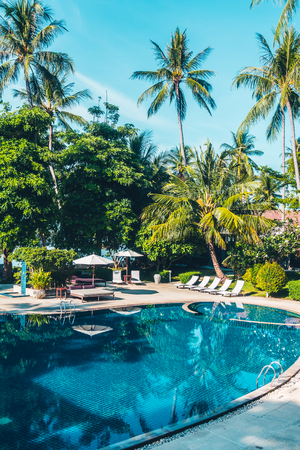 Beautiful luxury outdoor swimming pool with umbrella and chair in hotel and resort for travel and vacationのeditorial素材