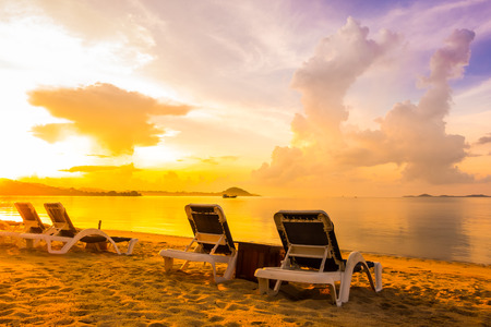 Beautiful outdoor view with empty bed chair on the tropical beach and sea at sunrise time for holiday travel and vacationの写真素材