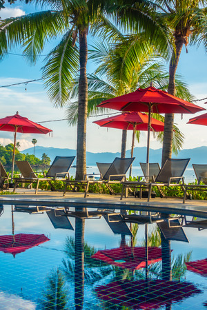 Beautiful luxury outdoor swimming pool with umbrella and chair in hotel and resort for travel and vacationのeditorial素材