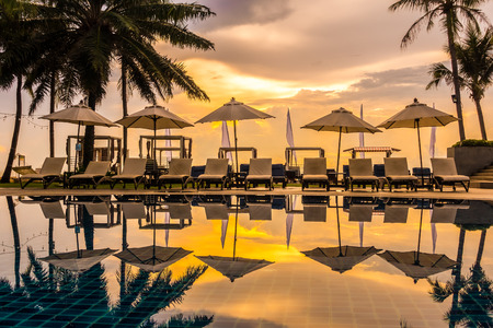 Beautiful luxury outdoor swimming pool with umbrella and chair in hotel and resort for travel and vacationのeditorial素材