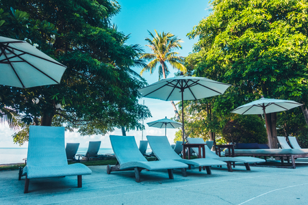 Beautiful luxury outdoor swimming pool with umbrella and chair in hotel and resort for travel and vacationのeditorial素材