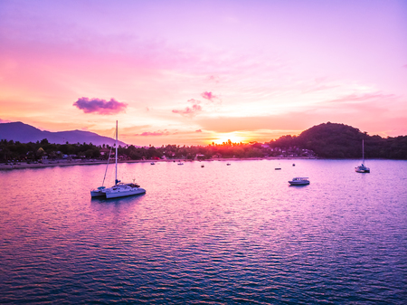 Aerial view of beautiful tropical beach and sea with palm and other tree in koh samui island Thailand at sunset time for vacation and travelの写真素材