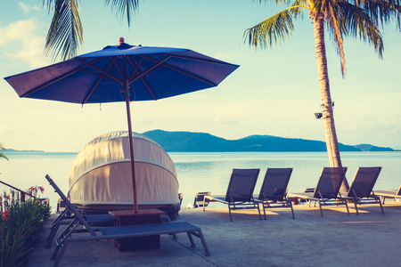 Beautiful outdoor view with umbrella and chair around swimming pool in luxury hotel and resort at sunrise time for travel and vacationのeditorial素材