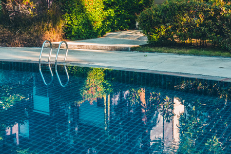 Beautiful luxury outdoor swimming pool with stair in hotel and resort for holiday travel and...