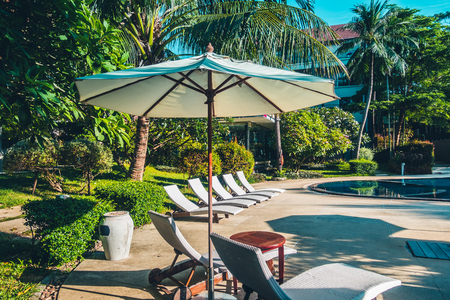 Beautiful luxury outdoor swimming pool with umbrella and chair in hotel and resort for travel and vacationのeditorial素材