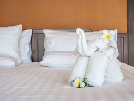 White elephant towel and comfortable pillow on bed decoration in hotel bedroom interiorの写真素材