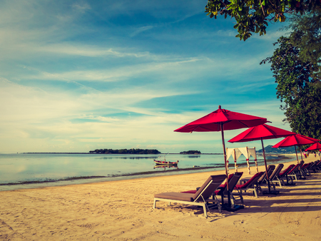Umbrella and chair on the tropical beach sea and ocean for travel and vacationの写真素材
