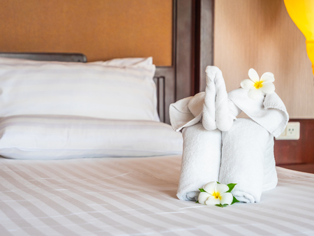 White elephant towel and comfortable pillow on bed decoration in hotel bedroom interiorの写真素材