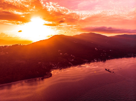 Aerial view of beautiful tropical beach and sea in island at sunset time for travel and vacationの写真素材