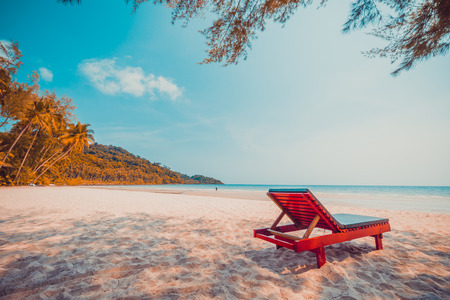 Beautiful nature tropical beach and sea with chair and coconut palm tree on paradise island for travel vacationの写真素材