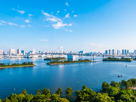 Beautiful cityscape with architecture building and rainbow bridge in tokyo city japan on blue sky and white cloudの写真素材