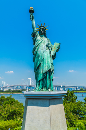 Liberty statue with rainbow bridge in odaiba island tokyo japanの写真素材