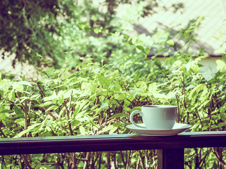 Outdoor patio with beautiful nature view and white coffee cup for relaxの写真素材