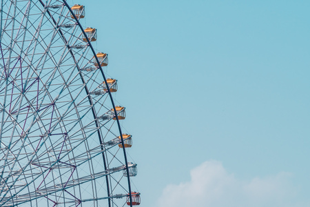 Ferris wheel in amusement festival park on blue sky backgroundの写真素材