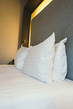 White pillow on bed decoration in hotel bedroom interiorの写真素材