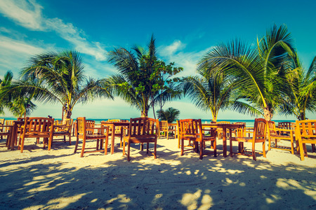 Beautiful outdoor sea and ocean view with umbrella and chair around coconut palm tree for travel and vacationの写真素材