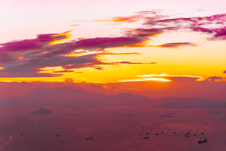 Beautiful colorful sunset in hong kong city skyline with sea and ocean bay