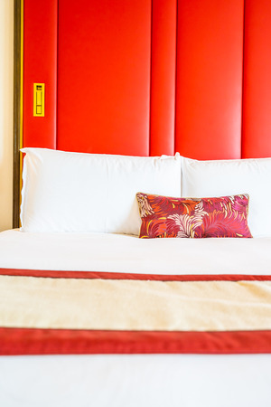 Comfotable pillow on bed with light lamp decoration interior of bedroomの写真素材