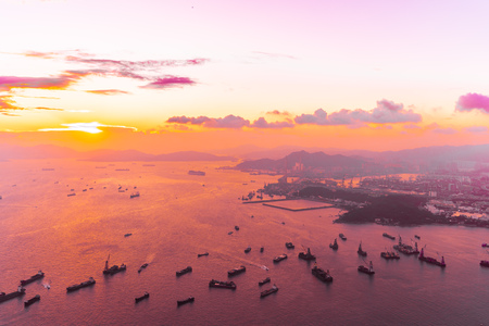 Beautiful colorful sunset in hong kong city skyline with sea and ocean bay