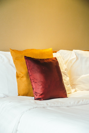 Comfortable pillow on bed with light lamp furniture decoration interior of hotel bedroomの写真素材