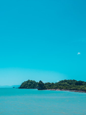 Beautiful tropical sea ocean with white cloud on blue sky background for travel and vacationの写真素材