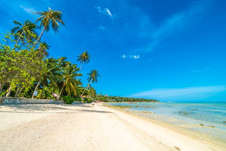 Beautiful tropical beach sea and sand with coconut palm tree on blue sky and white cloud for travel and vacationの写真素材