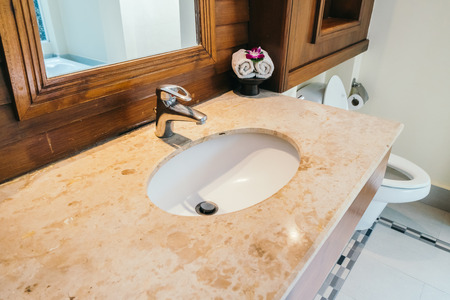 White sink and water facuet decoration in barhroom interiorの写真素材