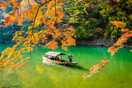 Beautiful Arashiyama river with maple leaf tree and boat around lake in Autumn season Kyoto Japanのeditorial素材